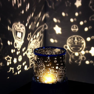 Colorful star projector lamp casting star and character patterns on walls, creating a magical night sky effect.