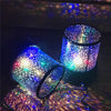 Colorful star projector lamp displaying vibrant light patterns on surfaces, ideal for night relaxation and ambiance.